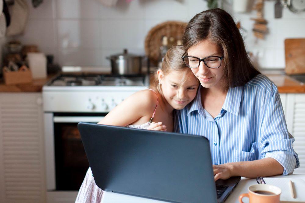 A mother balancing work and family, working from home with her child